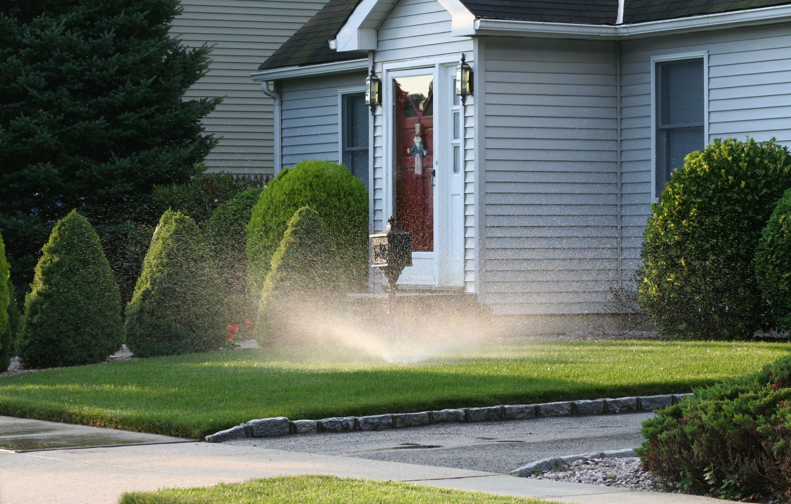 A sprinkler spraying a lawn in the morning, in Georgia.